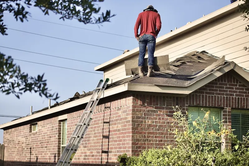 Professional roofer working on a residential roof in Middlesex Village